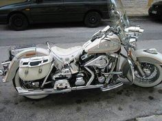 a white motorcycle is parked on the street