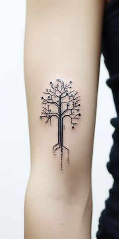 a woman's arm with a tree tattoo on it