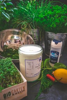 herbs and candles are sitting on a table