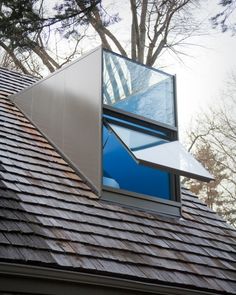 the roof of a house with a triangular shaped window