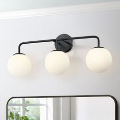 This 3-Light bathroom vanity light fixture is a great blend of mid-century classic and contemporary styles. It features 3 frosted white opal glass shades and gently arched arms in matte black, which looks low-profile but has the elegant and minimalist aesthetics. The glass globe wall light is an eye-catching and focal piece to help build a timeless interior decor, which is ideal for over bathroom mirror or in a bedroom, powder room or living room to add chic urban romance. True Fine Carousel 26. Vanity Lighting Over Mirror, Black Bathroom Light Fixtures, Bathroom Vanity Light Fixture, Black Bathroom Light, Globe Wall Light, Vanity Lights Bathroom, Black Vanity Bathroom, Cabin Bathrooms, Black Vanity Light