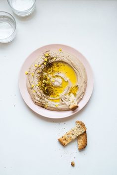 a plate with hummus and some crackers on it