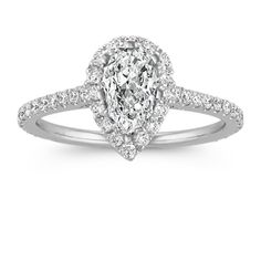 a pear shaped diamond engagement ring with pave set shoulders