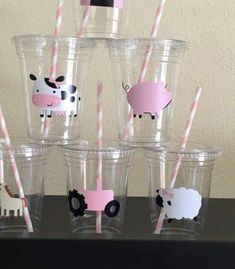 there are many cups with straws in the shape of animals and farm animals on them