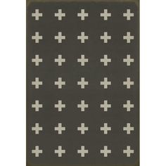 a black and white rug with crosses on the ground in front of a gray background