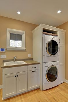 a washer and dryer in a room with wood floors