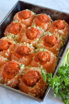 a baking pan filled with meatballs and broccoli