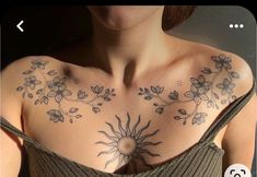 a woman's chest with sun and flowers on it