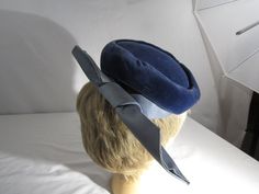 the hat has combs on each side to hold hat in place. Formal Blue Winter Hat, Blue Formal Winter Hat, Vintage Fitted Blue Hats, Vintage Blue Hat For Evening, Vintage Blue Hat For Formal Occasions, Blue Vintage Hat For Evening, Vintage Blue Formal Hat, Blue Fitted Vintage Mini Hats, Cloche Hats