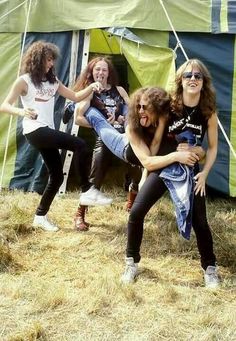 group of young women dancing in front of a tent with their arms around each other