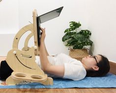 a woman is laying on the floor with her laptop and tablet in front of it