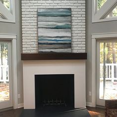 a living room filled with furniture and a fire place in front of a painting on the wall