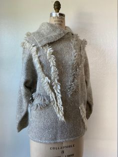 "1980's Fiore Italy Wool/Kid Mohair/Alpaca/Silk Asymmetrical Shawl Collar / Dolman Sleeve / Sweater with Abstract Textured Detailing Label: Fiore Tags:  45% Lana Wool, 30% Kid Mohair, 10% Alpaca, 10% Polyamide, 5% Silk | Made in Italy | Hand Wash, Line Dry Condition: Great (no tears, holes or stains) Specs: - grey and white marled, slub yarn - textured, fuzzy body - grey and white abstract yarn lines running throughout - exaggerated asymmetrical shawl collar - long sleeve, dolman style Measurements: - 21\" armpit to armpit - 23\" nape of neck to hemline - 21\" shoulder seam to shoulder seam - 17\" armpit to cuff - 17\" waist (un-stretched & stretched out laid flat) Content:   Lana Wool, Kid Mohair, Alpaca, Polyamide, Silk Any additional questions, please don't hesitate to message me!" Asymmetrical Shawl, Slub Yarn, Dolman Sleeve Sweater, Nape Of Neck, Carlisle, Shawl Collar, No Tears, Dolman Sleeve, Sleeve Sweater