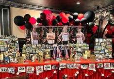 a table topped with lots of pictures and balloons