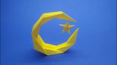 an origami star and moon on a blue background