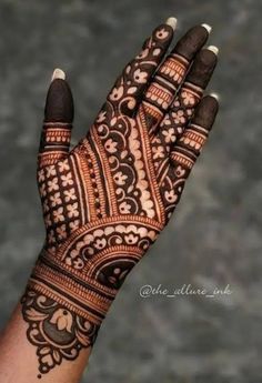 the hand is decorated with henna and flowers