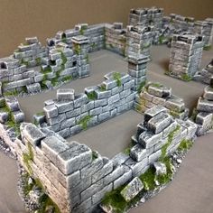 a model of an old stone building with moss growing on it