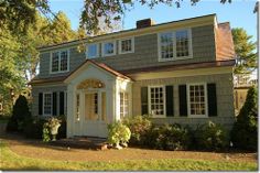 a house with white trim and black shutters