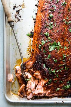 a roasting pan filled with meat and garnished with parsley