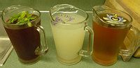 three different types of drinks sitting on a counter