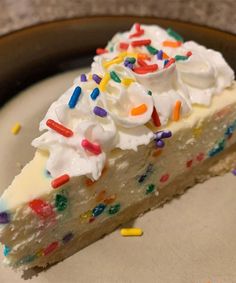 a slice of birthday cake with white frosting and sprinkles