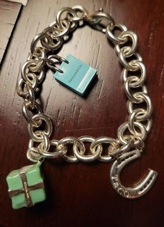 You are purchasing a Tiffany & Co. Charm Bracelet with Three Charms with Original Box 40 Grams 7.5". See pictures of the item you are purchasing. The shipping is free. Tiffany Charm Bracelet, Tiffany And Co, Fine Jewelry Bracelets, See Pictures, Tiffany & Co., Original Box, Jewelry Watches, Jewelry Bracelets, Fine Jewelry