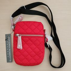 Sondra Roberts Quilted Nylon Cellphone Crossbody Bag Brand New With Tabs Color Red Zippered Front Pocket Slip Rear Pocket Adjustable Shoulder Strap Three Interior Card Slots Black Strap Measurements Laying Flat: Wide ~5” Length ~ 7.5" Depth ~1” Shoulder Strap Adjustment From ~28” To ~48” Great For Traveling And Organizing Your Cards And Phone Casual Red Phone Bag With Removable Pouch, Casual Red Phone Bag With Adjustable Strap, Trendy Red Nylon Shoulder Bag, Red Rectangular Nylon Shoulder Bag, Cellphone Bag, White Crossbody Bag, Embossed Bag, Pink Crossbody Bag, Faux Leather Purse