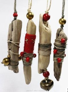 several pieces of driftwood hanging from strings with bells