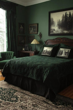 a bed in a green room with pictures on the wall above it and an area rug