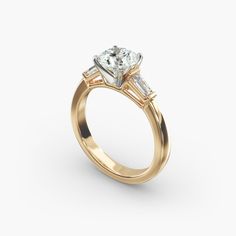 a yellow gold engagement ring with two princess cut diamonds