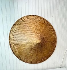 a round wicker basket hanging on the wall