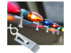 some lights are hanging on the side of a car with scissors in front of them