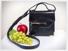 "Retro style black thick leather crossbody purse designed by MACKAGE. The pre-loved condition of this purse is very good; this is a hardy little crossbody bag with delightful gold metal detailing, the gold arrow is the closure when slipped into the opening. The stitching is intact, there are some surface scuffs but no damages. -7\" tall, 9\" tall with the handle -7\" wide -2\"  expands to 3\" deep -48\" long strap, adjustable Shipping -  I will ship internationally. Please contact me with your c Yuzefi Bag, Structured Purse, Strap Jeans, Fashion Mom, Velvet Shoes, Vintage Mens Fashion, Handcrafted Bags, Purse Crossbody, Rockabilly Fashion