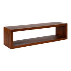 a wooden shelf sitting on top of a white wall in front of a white background