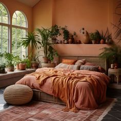 an orange bedroom with potted plants on the windowsill and a bed in front