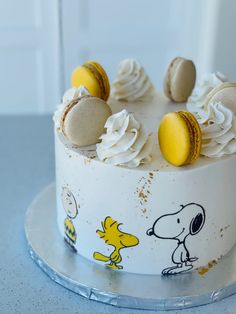 a white cake decorated with peanuts and macaroons