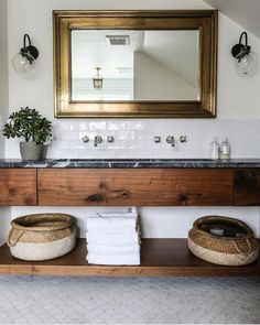 a bathroom with two baskets on the counter