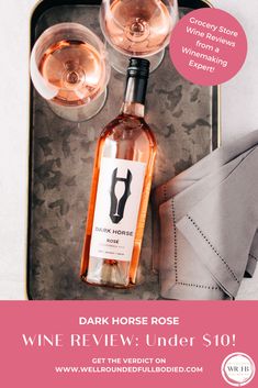 a bottle of wine and two glasses on a tray with the words dark horse rose under $ 10