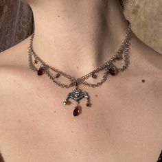 This beautiful Angel Drape choker is inspired by the Renaissance. It is made with iron chain, plastic beads and an iron pendant, so to prolong its life, do not wear in water. 15.5 inch chain Please message me with any questions or concerns! 🤍🕊️ Metal Beaded Choker Necklaces With Adjustable Chain, Metal Choker With Beaded Chain, Metal Beaded Choker As A Gift, Metal Beaded Choker With Adjustable Chain, Metal Beaded Choker Necklace For Gift, Silver Metal Choker With Beaded Chain, Metal Chain Dangle Choker, Adjustable Fantasy Style Choker, Brown Metal Choker Necklace