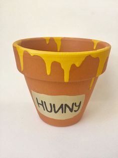 a clay pot with yellow glaze on it that says humongous in the center