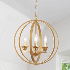 an orb chandelier with three lights hanging from it's sides in a white room