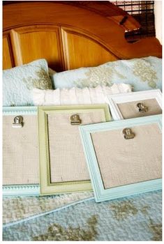 there are three frames on the bed and one has two clipboards attached to it