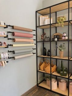 the shelves are organized with different types of crafting supplies and paper rolls on them