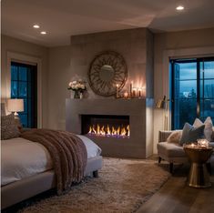 a bedroom with a fire place in the fireplace and two couches on either side