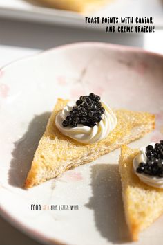 two pieces of cake on a plate with black cavias in the middle and whipped cream on top