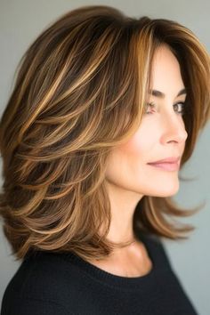 Save this pin for the best medium-length layered haircuts for older women. These pretty layers bring a warm, inviting tone to your hair, while feathered volume adds fullness. The feathered ends create a rounded shape that’s perfect if you want a little extra body without adding length. Elegant Brunette, Hair Trends 2024, Brunette Hair Color Ideas, Relaxed Pose, Natural Brunette, Hair Tomboy, Women's Haircuts, Rambut Brunette, Layers Medium