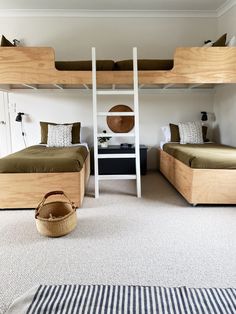 a bedroom with two bunk beds and a basket on the floor