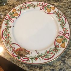 a turkey plate with holly and pears around the rim on a granite countertop