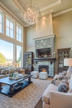 a living room filled with furniture and a fire place in front of a large window