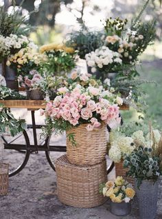 a table topped with baskets filled with flowers